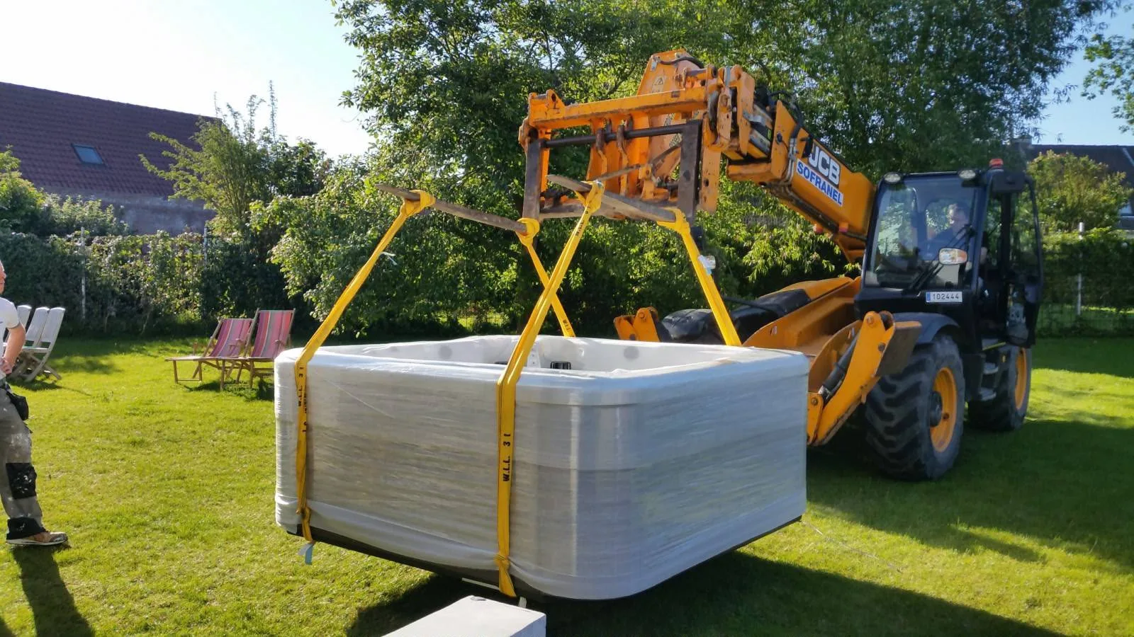 Mise en place d'un spa dans un jardin à l'aide d'un chariot télescopique